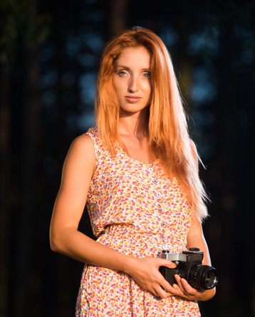 Hot redhead Michelle H wanders through lush countryside with her camera