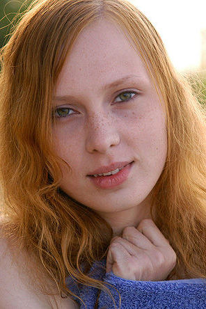 Redhead teen having fun by the lake